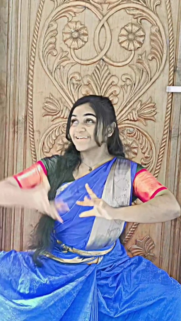 An asian dancer in saari costume dancing classical bharatnatyam classical dance.
