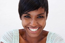 A beautiful smiling african american woman looking on camera . All Photos by Kazzakova